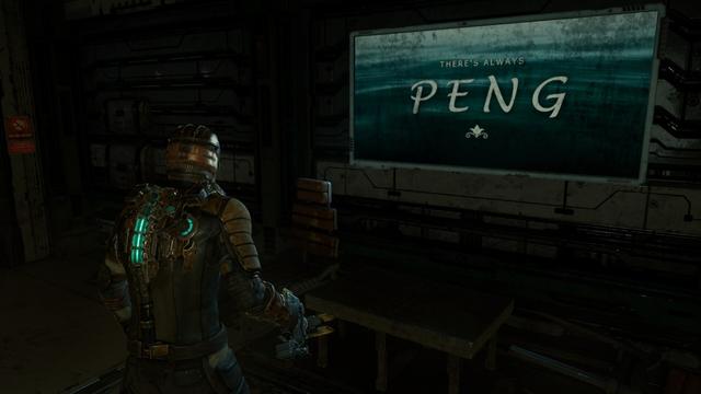 Isaac stands in front of a poster that reads: There's always PENG