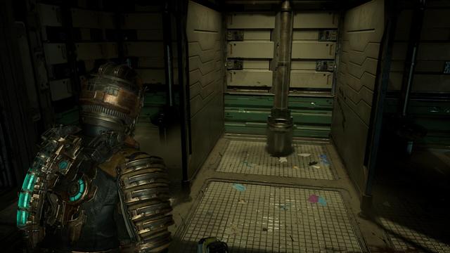 Isaac standing in a completely dark area where a single toilet cubicle with no door is brightly illuminated