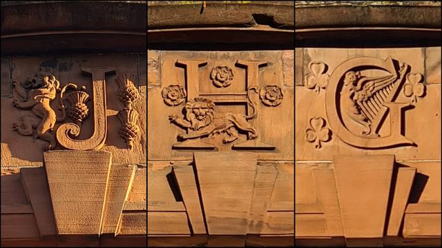 The letters J, H and G sculpted onto the facade of a Glasgow building, each decorated with different national symbols from the three kingdoms of the UK.