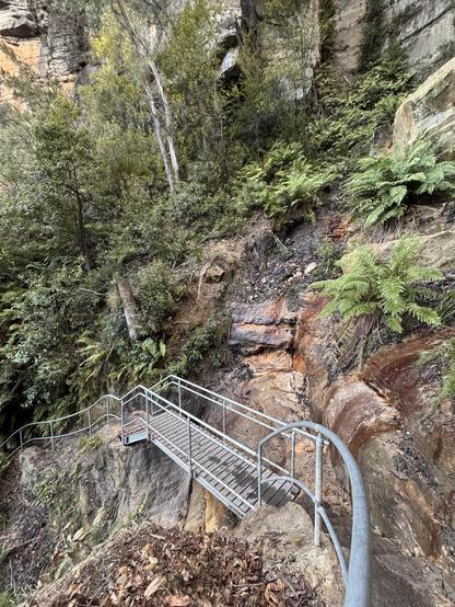 A new metal walking bridge, spanning a section of recently washed away track