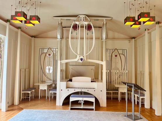 The piano in the music room in the House for an Art Lover, in typical Mackintosh style.