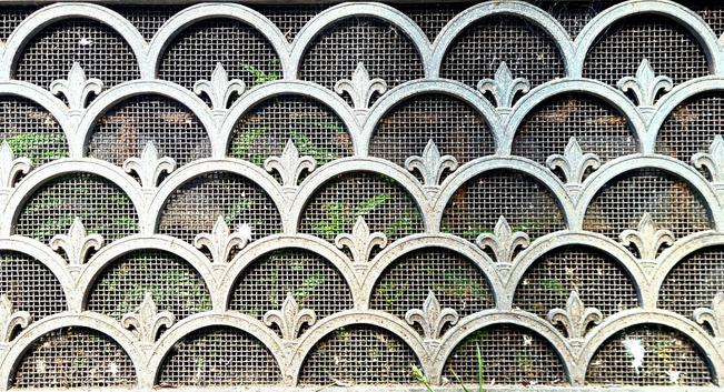 A decorative cast-iron air vent cover.