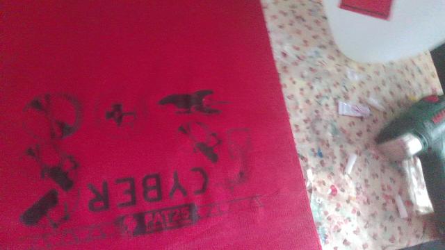 red table coth with black logos of fat25 printed on it on a Workshop table