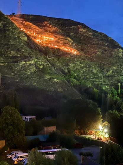Trail of burning falles coming down the mountain in the night.