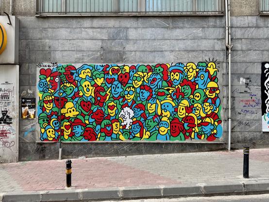 red green and blue cartoon faces in a graffiti piece
