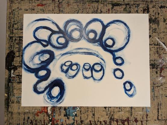dark blue painted abstract sketch on white paper on drawing board