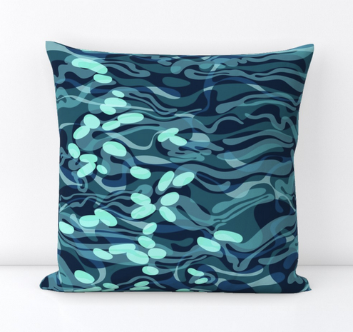 A mockup of how the abstracted fabric pattern representing the surface of moving water would look as sewn into a square stuffed pillow. The fabric is in tones of teal green.