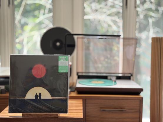 Deep Sea Diver - Impossible Weight LP cover.

A dark sky and earth, with two people looking at a bright yellow sunset, with a red sundog above.

The "sea foam green" LP plays on a vintage, restored Bang & Olufsen Beogram 4000 linear-tracking turntable to the right.