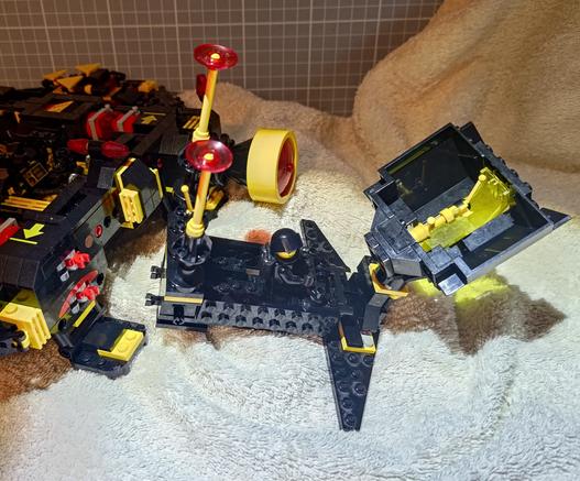A small Blacktron Lego build of the "Instigator" is preparing to dock to a bigger one, the "Renegade" from 2025.