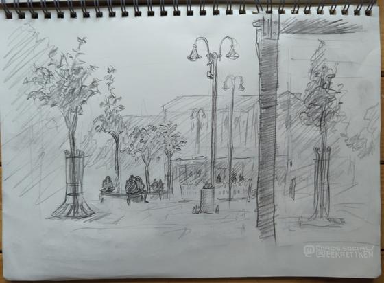 Pencil on paper

City scene. A station forecourt, various sidewalks (with a pair of shoes hanging from one) and seats on which people are sitting. A bus stands behind barriers. Houses and trees in the background.
