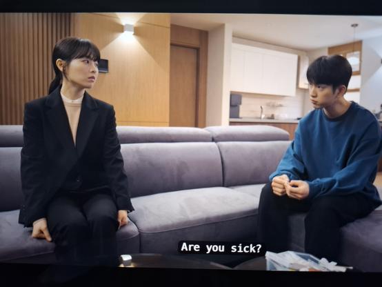 Still from Our unwritten Seoul with the female lead asking the male lead wether he is sick while paying no attention whatsoever to him applying a band -aid all by himself