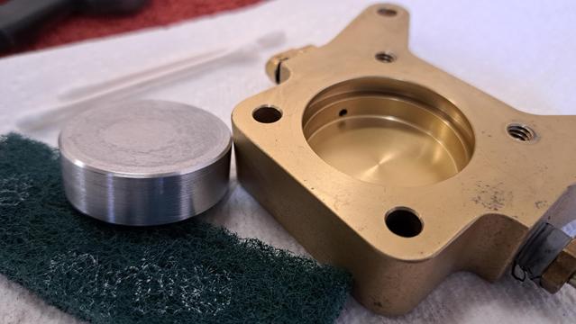 The scotch Brite pad removed the dirt and grease, but I'm not happy with the piston's surface quality on the edge. It will wear the rubber O-ring with repeated use.