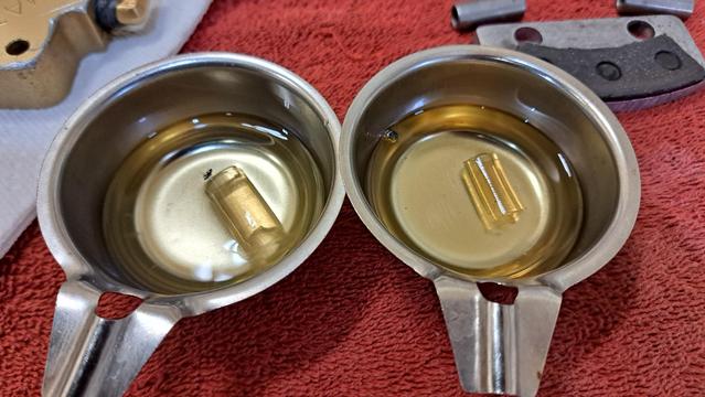 Two pieces of tubing are soaking in DOT 3 brake fluid. Tygon on the left, vinyl on the right.