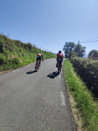 Cyclist being overtaken by another cyclist that is racing in a triathlon.