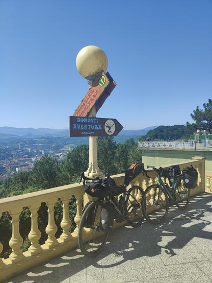 Two bicycles next to a sign "Donosti Aventura".