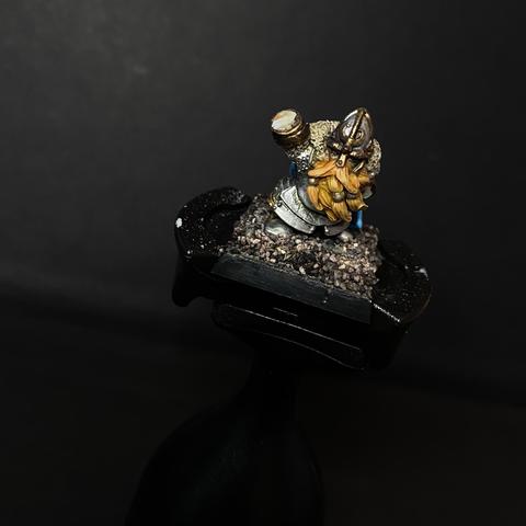Handless Mordheim Dwarf Noble. Heavily armoured with lots of metals and a big ginger beard.