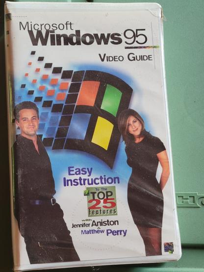 Photo of the VHS tape Microsoft Windows 95 Video Guide - Easy Instructions To The Top 25 Features with Jennifer Aniston and Matthew Perry from the cast of Friends.