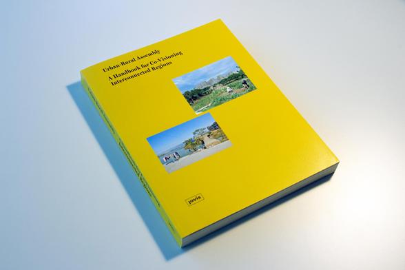 A yellow book with two photos on the cover lies at an angle on a light-coloured surface.