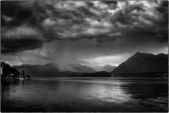 Schwarzweissfotografie eines Gewitters über den Berner Alpen über den Thunersee fotografiert.