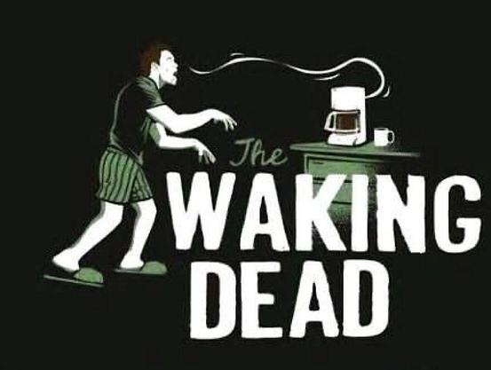 A tired, zombie like man walks over to the coffee maker dreadfully needing help to wake up.