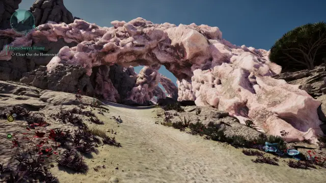 Avowed screenshot of a sand path leading under a natural arch of stone and pink crystal.