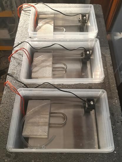 Three plastic reservoirs embedded in a block of polystyrene. Each reservoir is lined with aluminium and has a heating element and a little pump.
