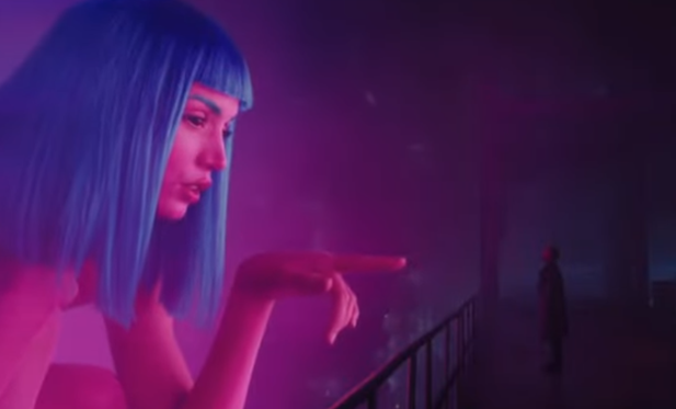 Scene from Blade Runner 2025. A giant neon-hued holographic Ana de Armas, naked with blue hair, kneels down and points directly at a tiny Ryan Gosling in a trench coat walking along an elevated walkway.