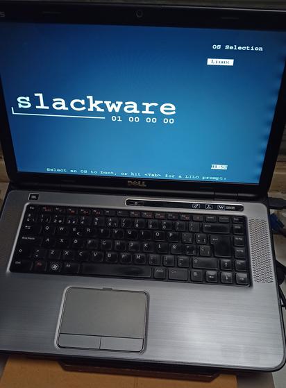 Laptop mostrando la pantalla de booteo de LILO con el logo de Slackware