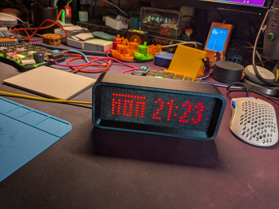 3d printed led matrix clock "ESPTimeCast"  showing the current time. Digits shining through 3d printed frontplate.