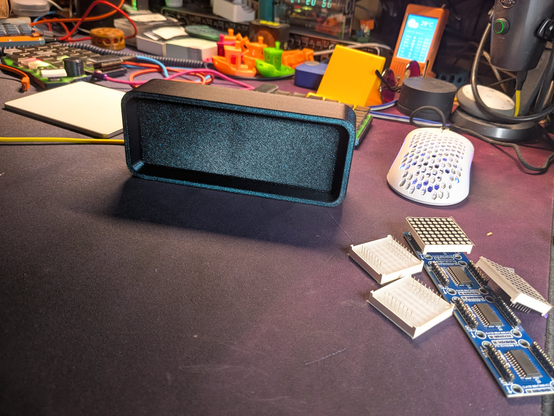 3d printed led matrix clock "ESPTimeCast"  showing the current time. Off state, looks like a monolithic  3d printed brick with a bevel.