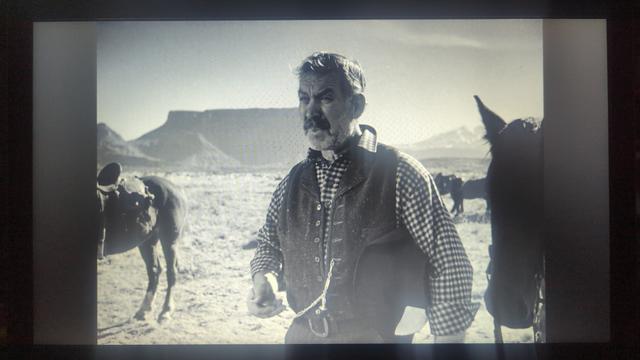 A photo of Wagon Master [1950] playing on my laptop, with Ward Bond standing among a few dusty old horses.