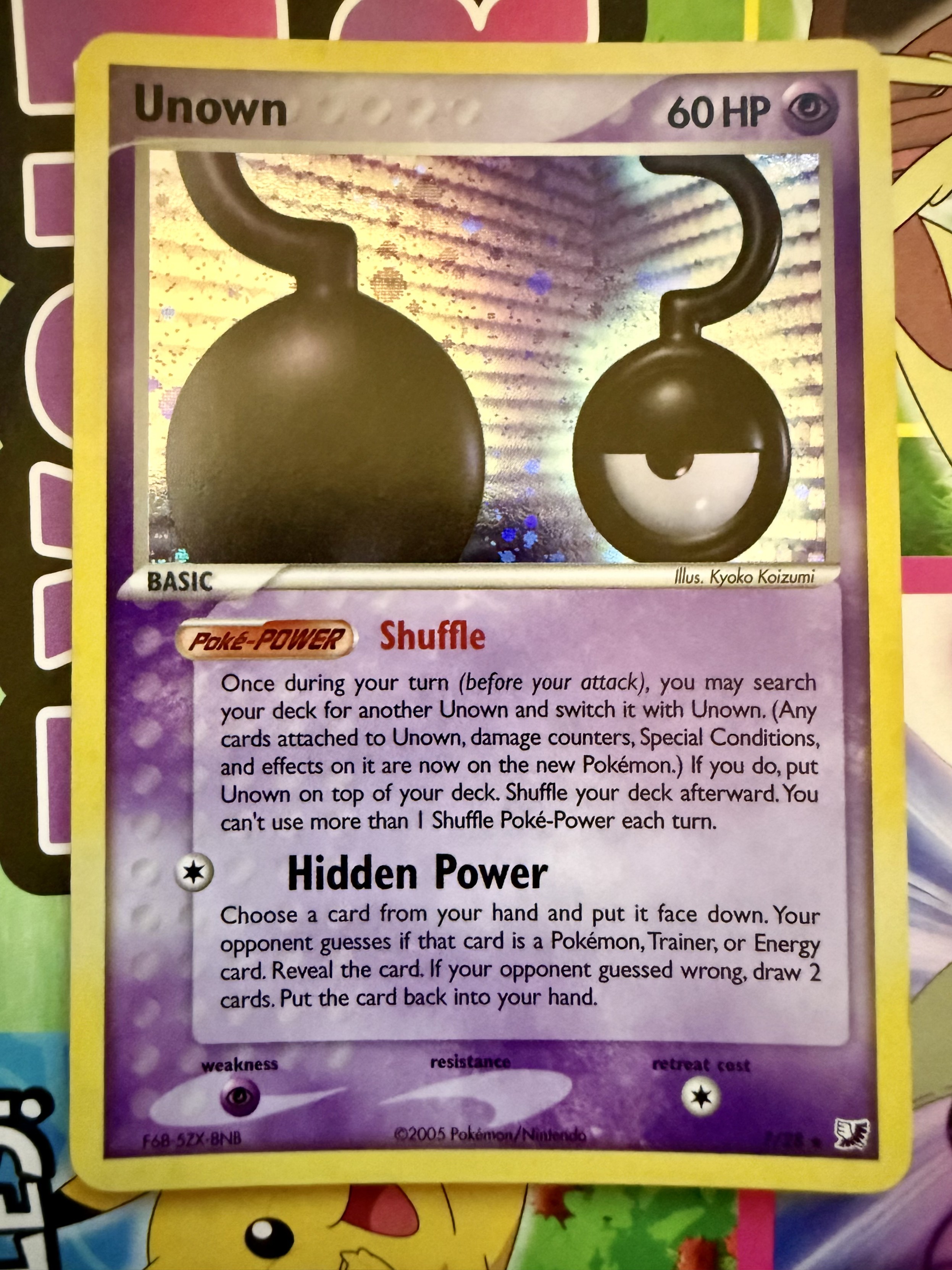 An Unown question mark Pokémon card from the Unseen Forces set.