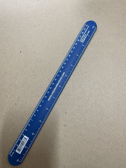 The same slap bracelet mentioned in the last photo, but unfolded revealing the ruler hidden on the underside.