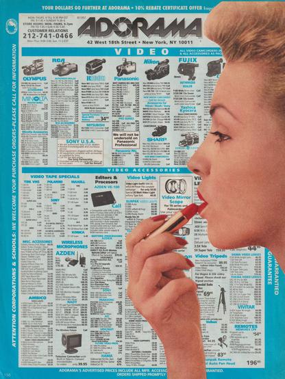 a femme puts the princess on in front of an ad for a camcorder store circa 1991