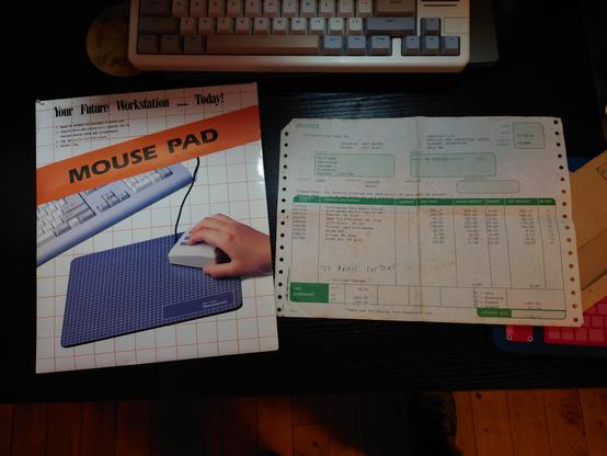 A picture of a sales receipt for the Acorn Archimedes A310 and the packaged mouse pad from 1990 laid out on my desk.
