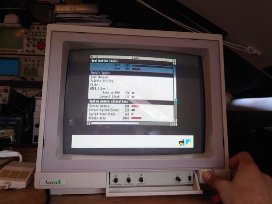 A picture of the Acorn Archimedes monitor sitting on my bench, showing a stable picture of the RISC OS 2 desktop UI with the Tasks monitor window open.