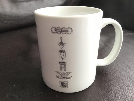 White mug showing the logos of Auto Union and its constituent brands