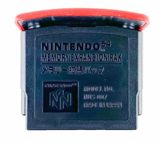 A Nintendo Memory Expansion Pak for the Nintendo 64. It is a black plastic square with a curved piece of red plastic on the top.