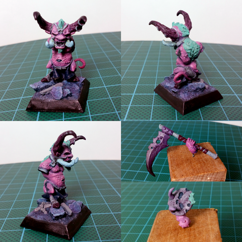 Picture of a mini, frame split into four panels.
Top left, top right and bottom left : different angles of a dwarf figurine, it got horns, a tail and an angry face, it's on a black square base with dark blue rocks.
Bottom right : the dwarf's weapons, a huge scythe and a shield having a face skin on it, with big fangs.

The whole mini is basecoated in shades of pink and some purple tints here and there. The horns are dark red/burgundy, its fur is light green. The scythe is a gradient of dark purple to purple.