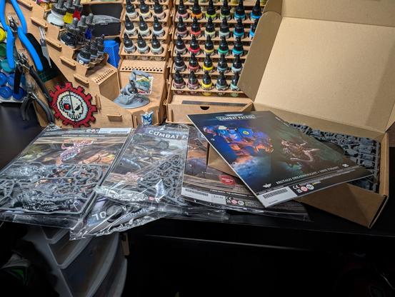 Photo of a stack of magazines and sprues on a desk.
