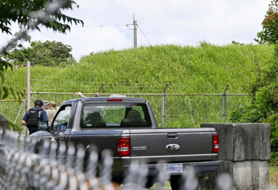 U.S military persons gather near the site of an explosion at a storage site for unexploded ordnances at a U.S military base, Okinawa, Southern Japan, on Monday…Photo Credit: Kyodo News via AP