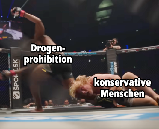 Frederic Vosgröne hält seinen Gegner im MMA-Kampf am Bein fest

Beschriftung:
Frederic Vosgröne = "konservative Menschen"
Gegner = "Drogenprohibition"