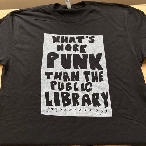 Black t-shirt with the text "What's more punk than the public library?"
