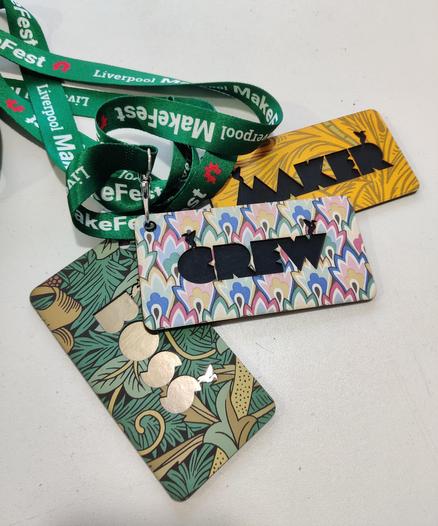 Photo shows 3 lanyard badges "Maker", "Crew" and "Boss" a vintage wallpapers from William Morris and Mary Quant.