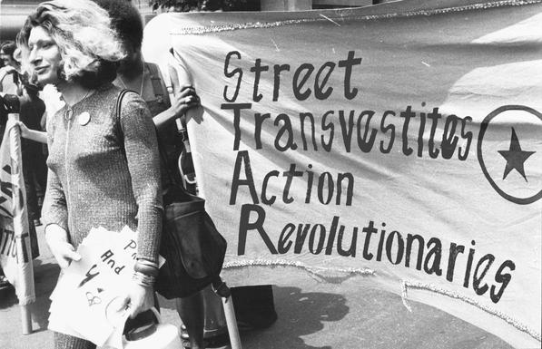 Sylvia Rivera with STAR banner (Street Transvestites Action Revolutionaries). By Roseleechs - Own work, CC BY-SA 4.0, https://commons.wikimedia.org/w/index.php?curid=119409579