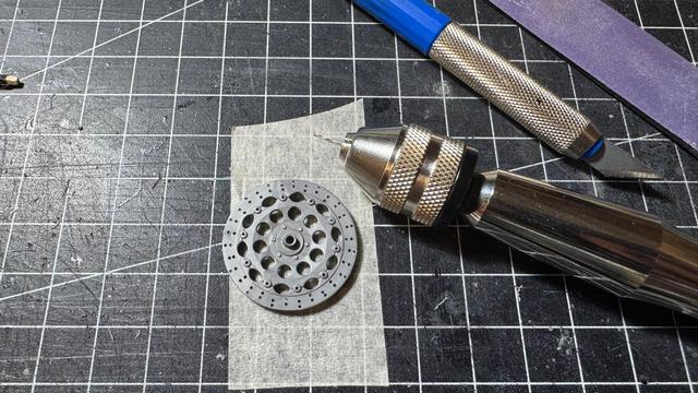 The progress of drilling tiny holes into brake discs of a Ducati 916 by Tamiya in 1:12 scale.