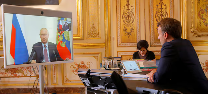 French President Emmanuel Macron and Russian President Vladimir Putin speak during a video conference at the Elysee Palace in Paris, France, June 26, 2020. Michel Euler/REUTERS