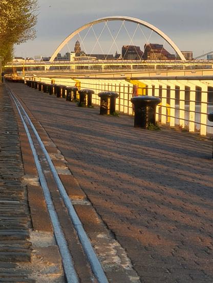 The remains of an old dock lining a modern walkway beside rhe Clyde in Glasgow.