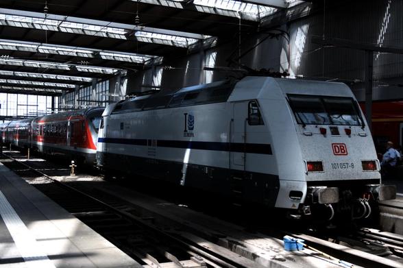 a BR101 in the same livery as the famous Europa ICE standing in munich central station and pulling a regio train
