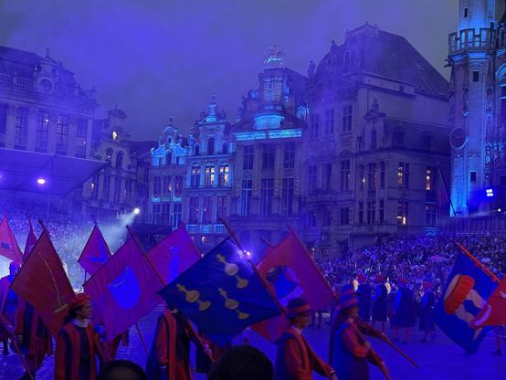 Grand Place with foot soldiers holding various flags.